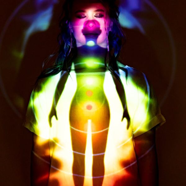 Woman performing a vibrant yoga pose, radiating positive energy.